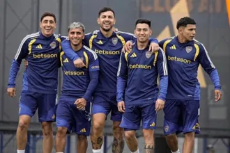 Cinco jugadores de Boca caminan juntos durante un entrenamiento.