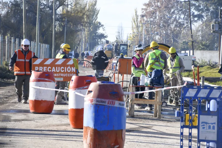 Personal trabaja en una obra de Aguas Mendocinas, delimitada con barreras y señalización.