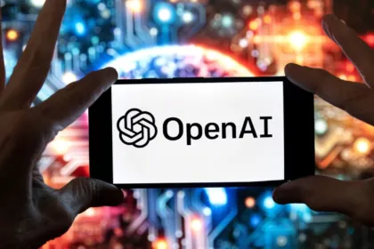 Un teléfono muestra el logo de OpenAI frente a luces de colores.