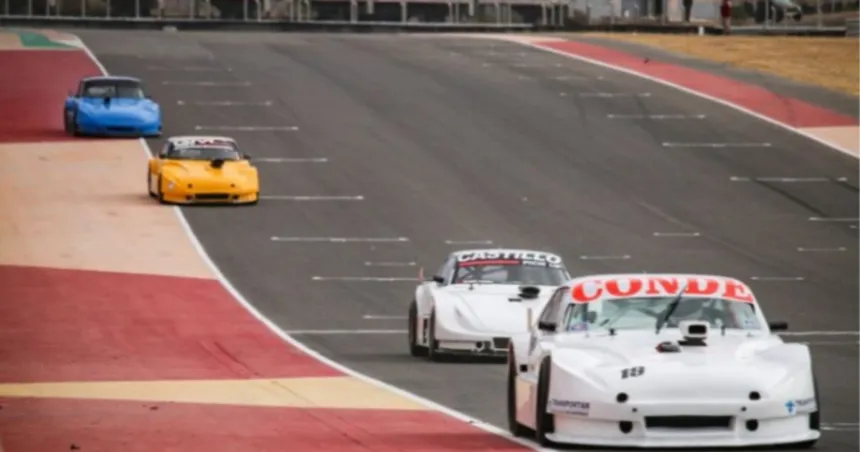 Autos de carrera circulan por la pista de un circuito.